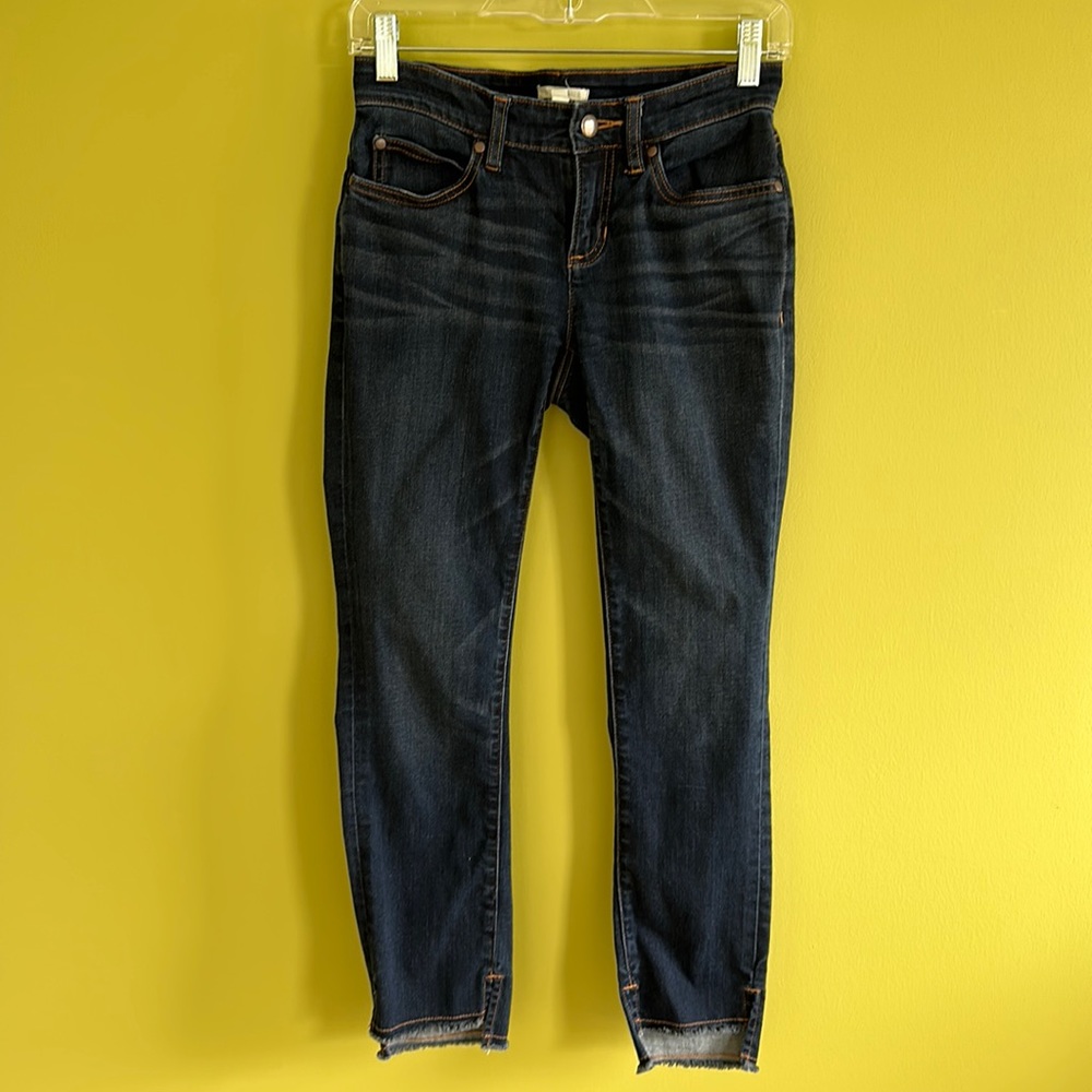Eileen Fisher dark blue skinny jeans with raw edge and gold stitching.